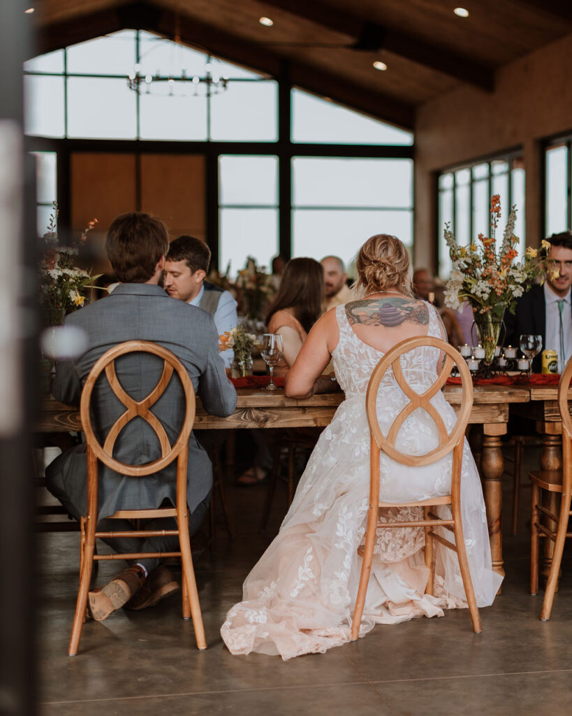 couple eats dinner with guests at reception