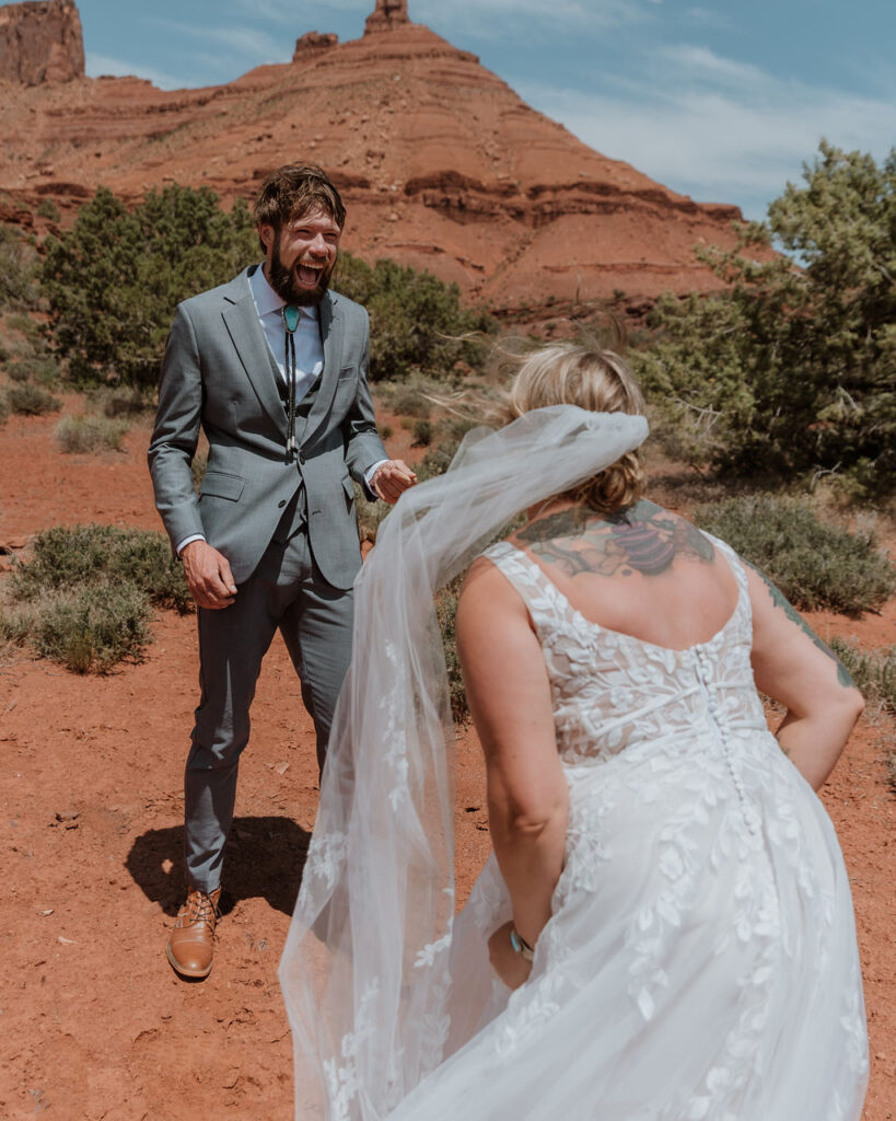 couple laughs together at Castle Valley wedding first look