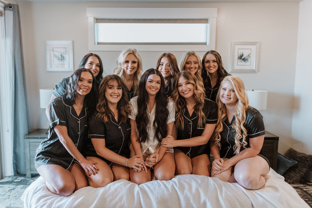 bride gets ready with bridesmaids on wedding day getting ready