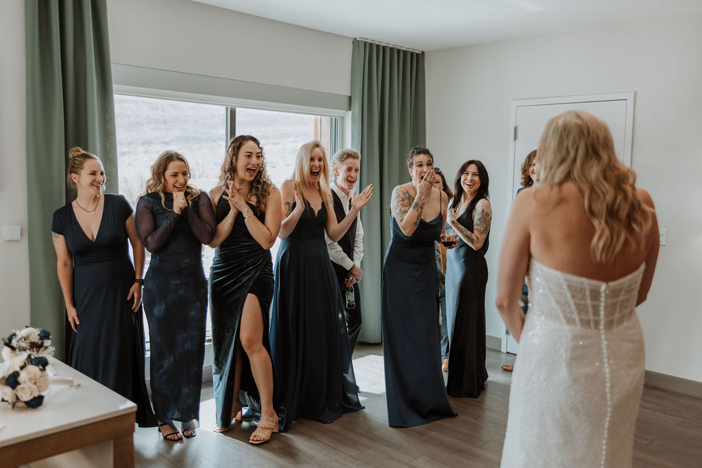 bride surprises bridesmaids during wedding getting ready