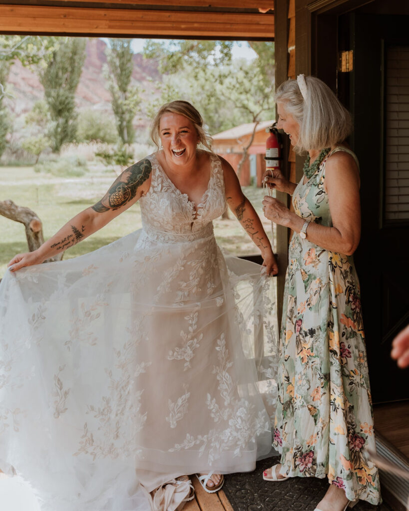 bride showcases wedding dress to family during wedding getting ready