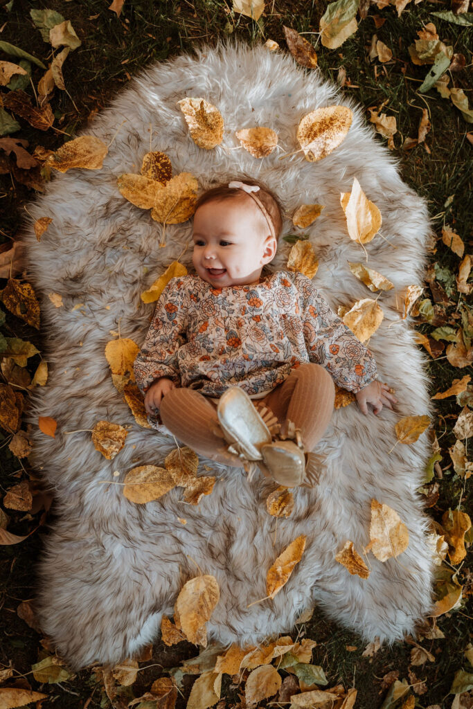 newborn photo with fall leaves and fur