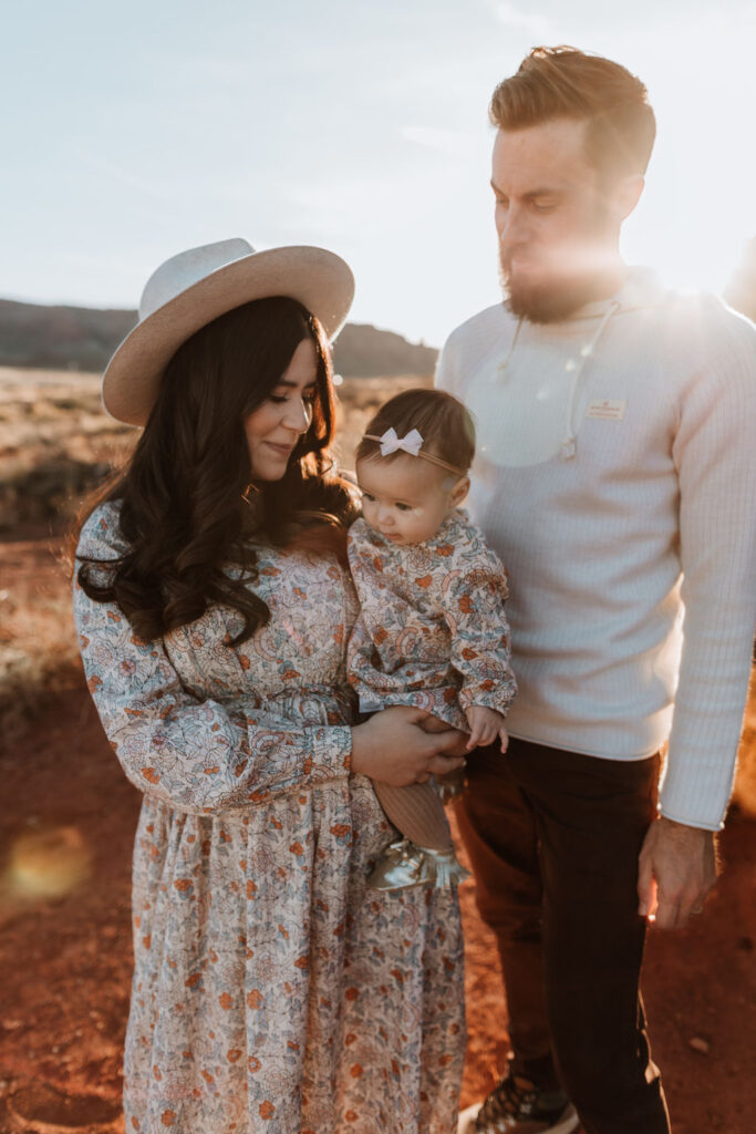 couple poses with newborn at Moab family photo session