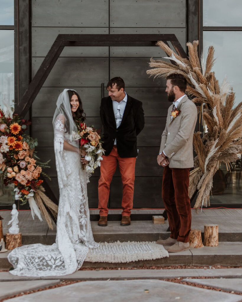 couple exchanges vows during The Red Earth venue Moab wedding ceremony