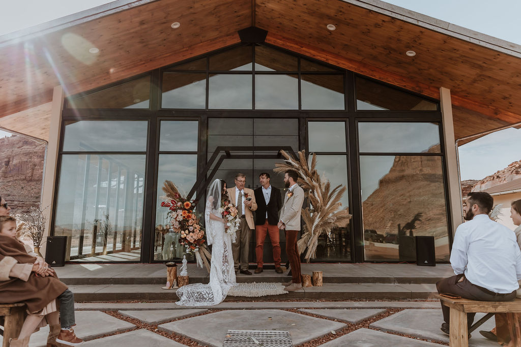 couple exchanges vows during The Red Earth venue Moab wedding ceremony