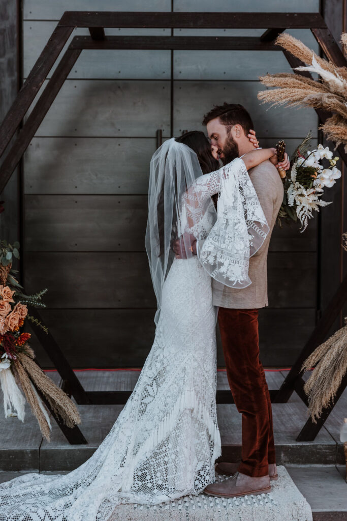 couple kisses at The Red Earth venue Moab wedding