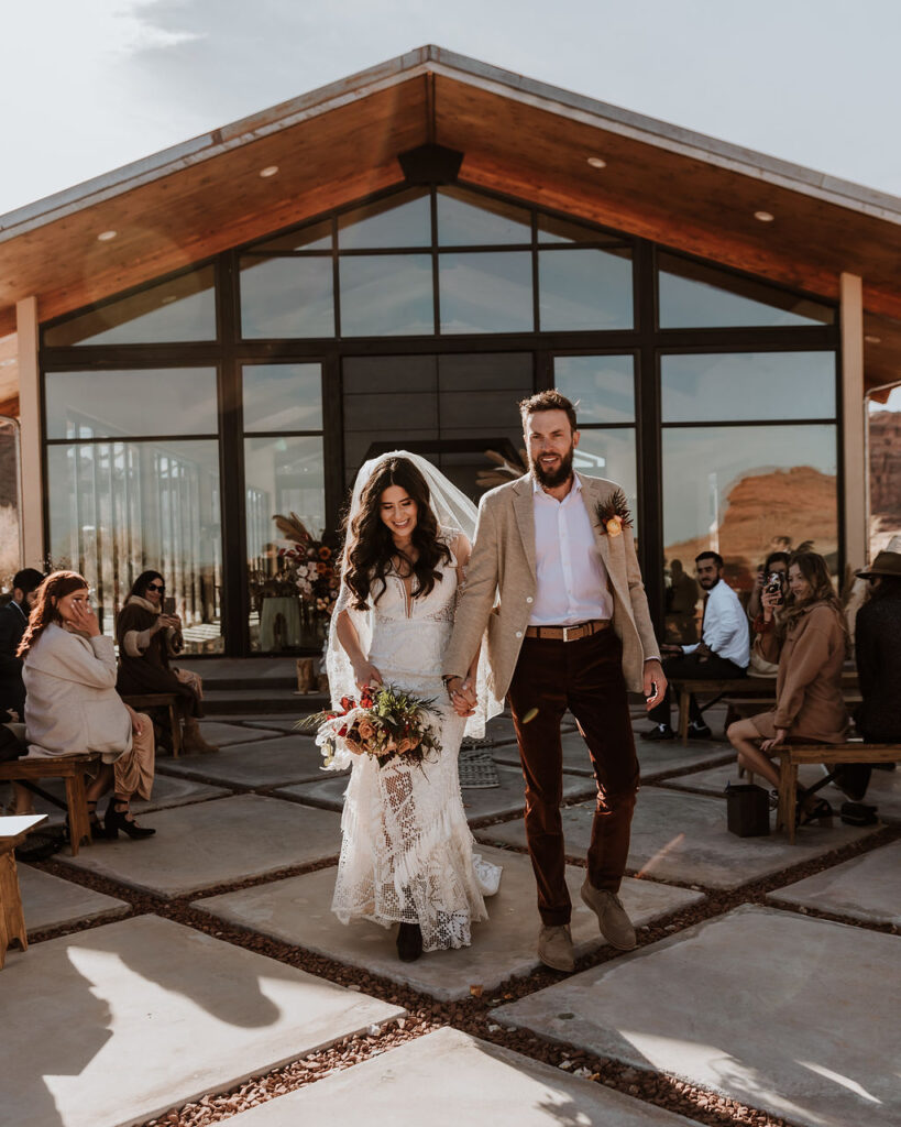 couple exits wedding ceremony at The Red Earth Venue Moab wedding