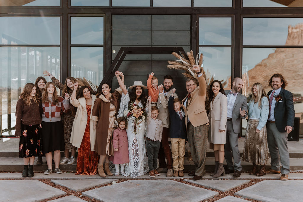 couple cheers with wedding guests