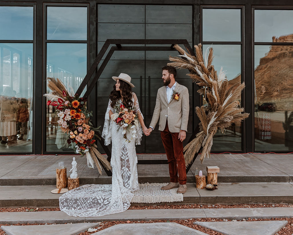 couple holds hands at The Red Earth Venue Moab wedding