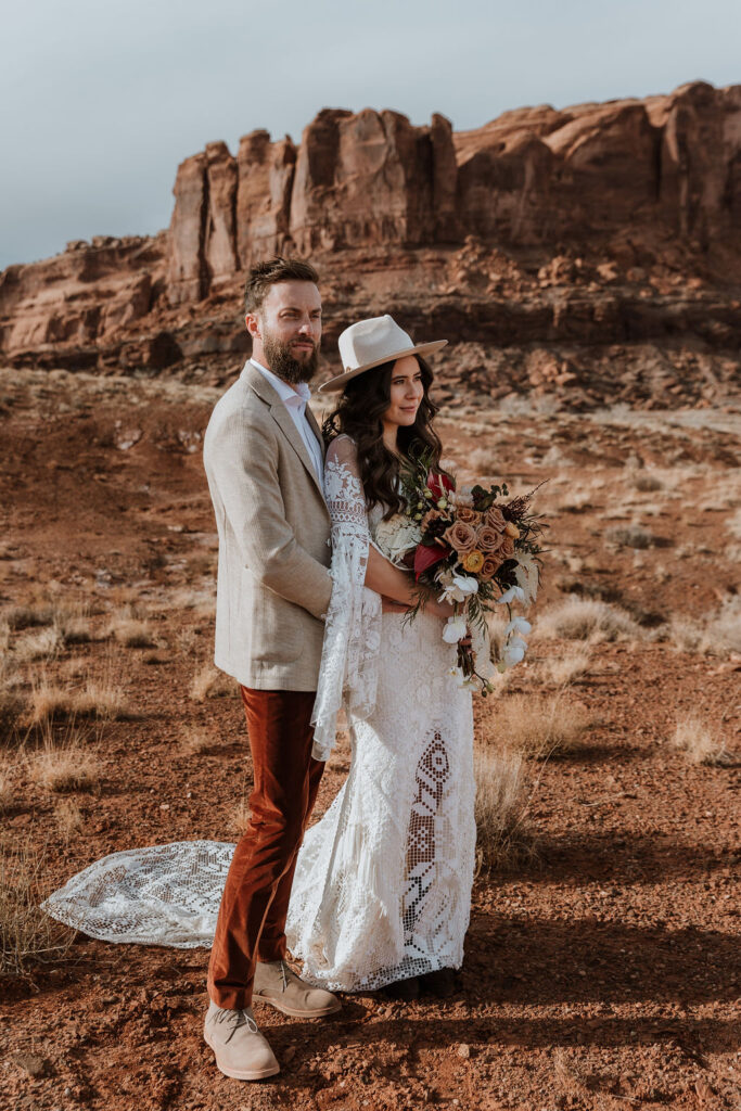 couple embraces at The Red Earth Venue Moab wedding 