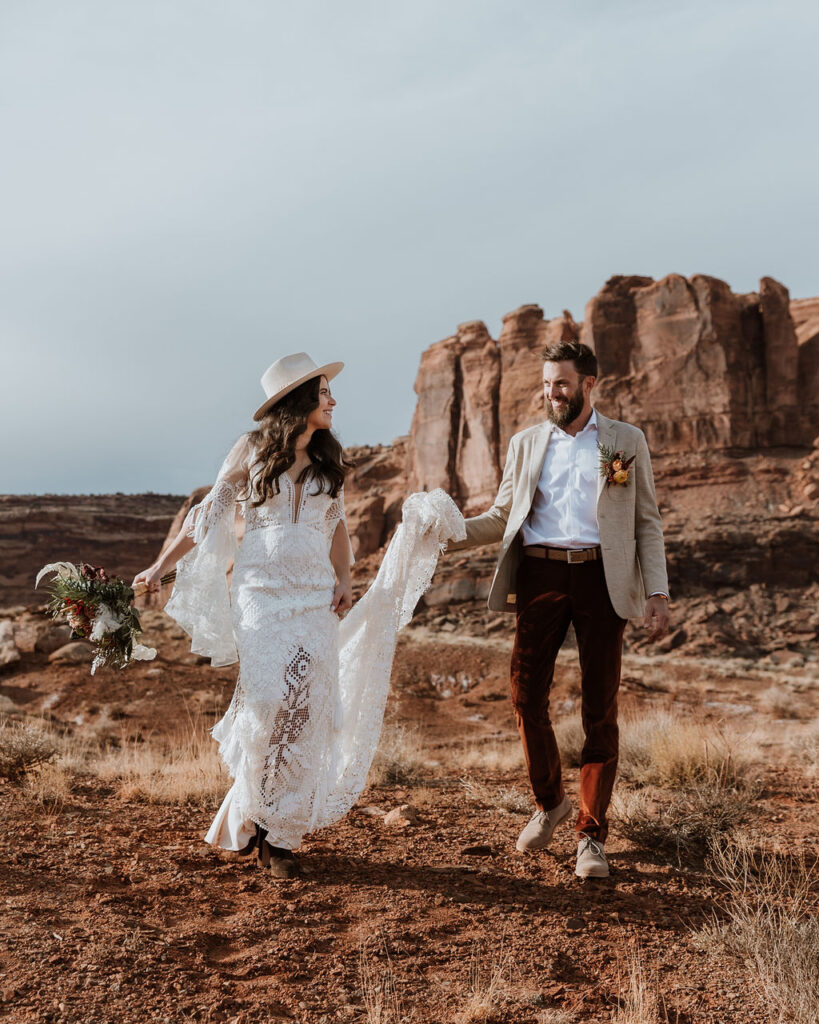 couple walks along Moab desert at The Red Earth Venue 