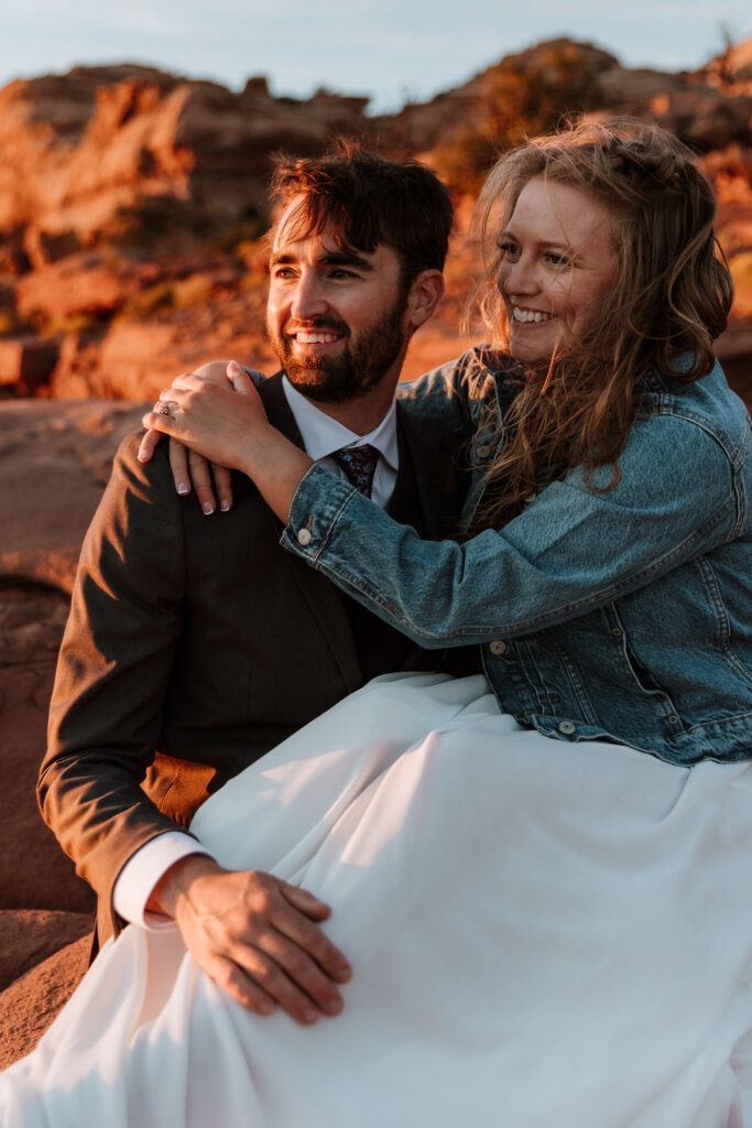 couple sits at Canyonlands National Park overlook