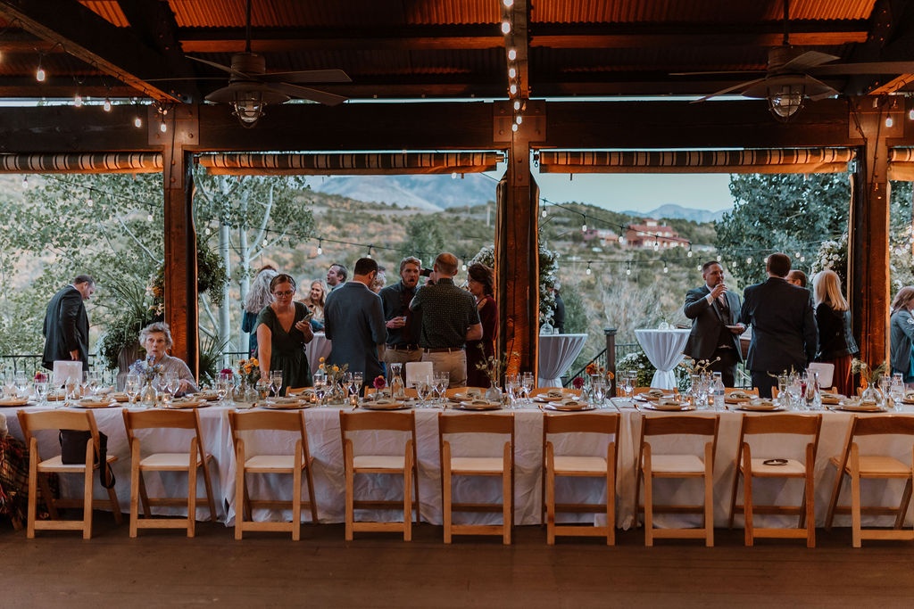 wedding guests mingle during cocktail hour at outdoor wedding 