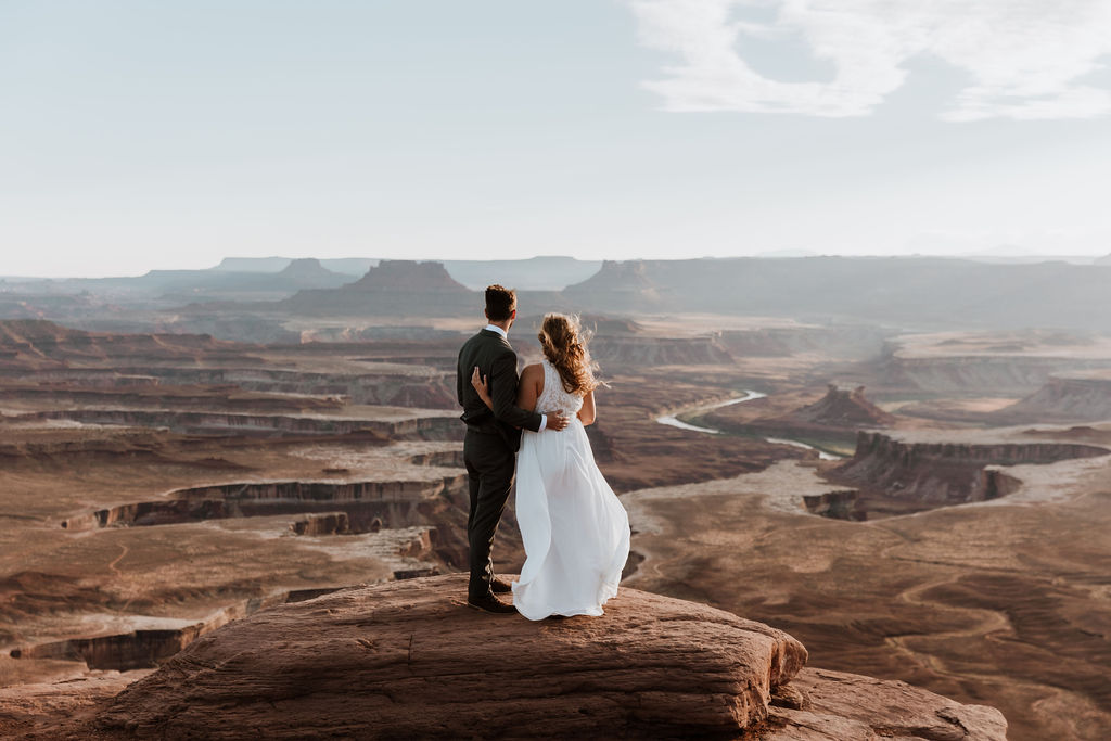 couple stands on overlook at Canyonlands National Park elopement