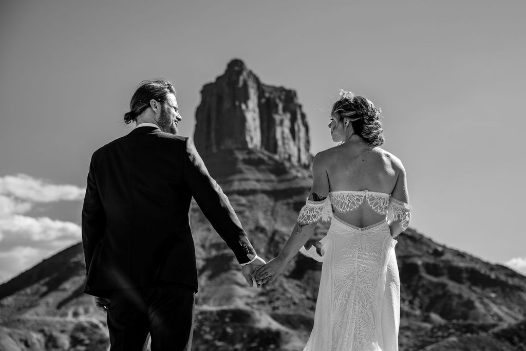 couple holds hands at Moab elopement