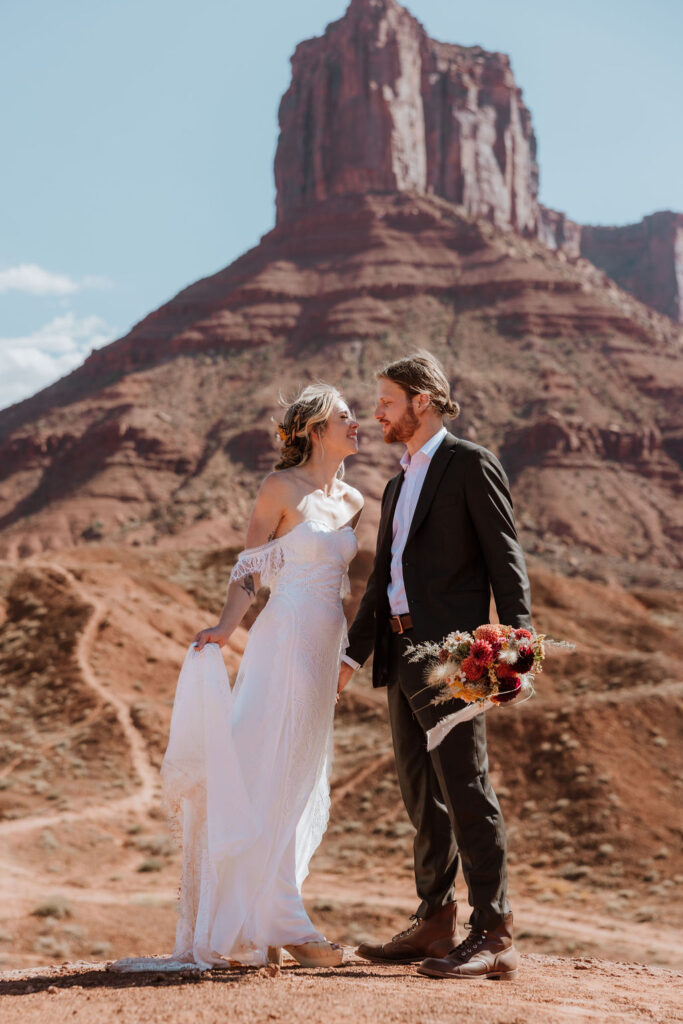 couple stands together at Moab elopement