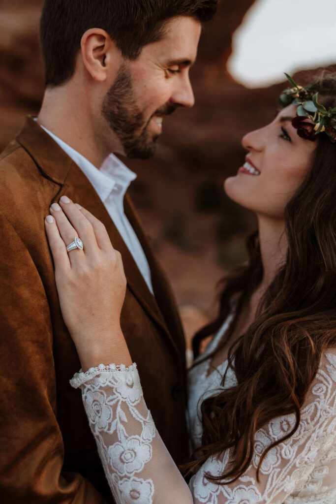 couple embraces at Arches National Park sunset elopement