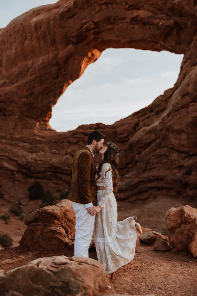 couple kisses at Arches National Park elopement