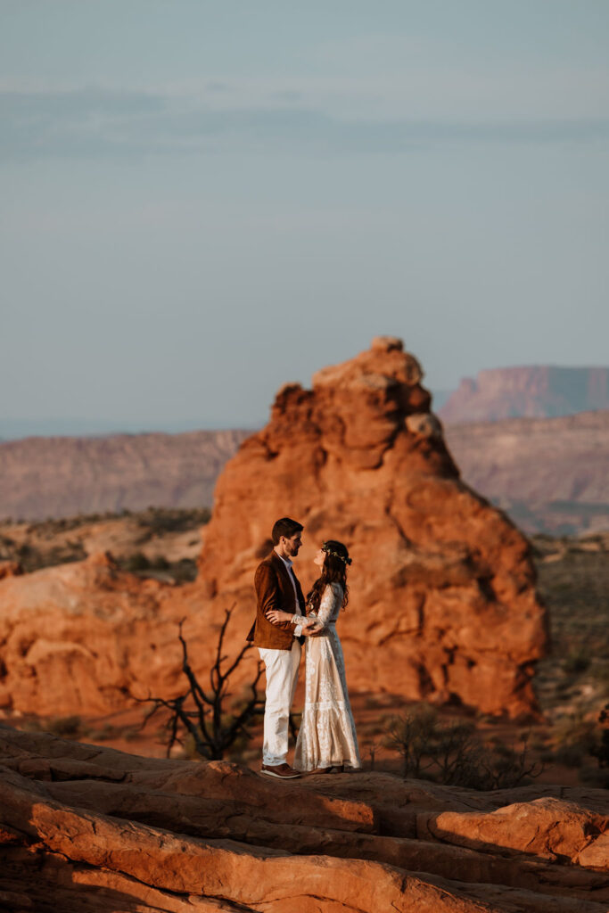 couple embraces at Arches National Park elopement