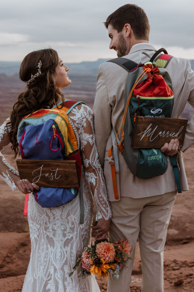 couple holds just married sign at backpacking elopement