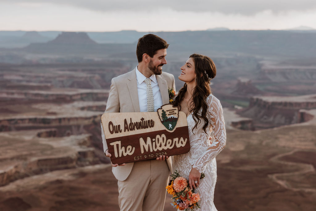 couple holds newly married national park sign