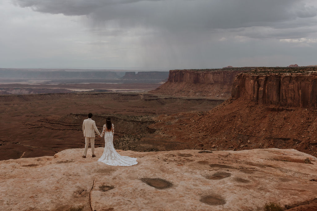 couple holds hands at Canyonlands National Park elopement