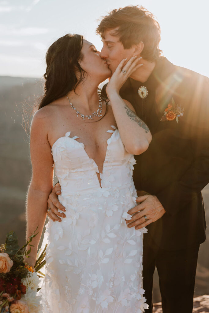 couple kisses at sunset Moab elopement