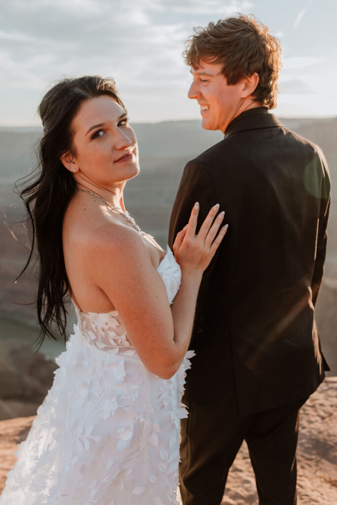 couple embraces at sunset Moab elopement