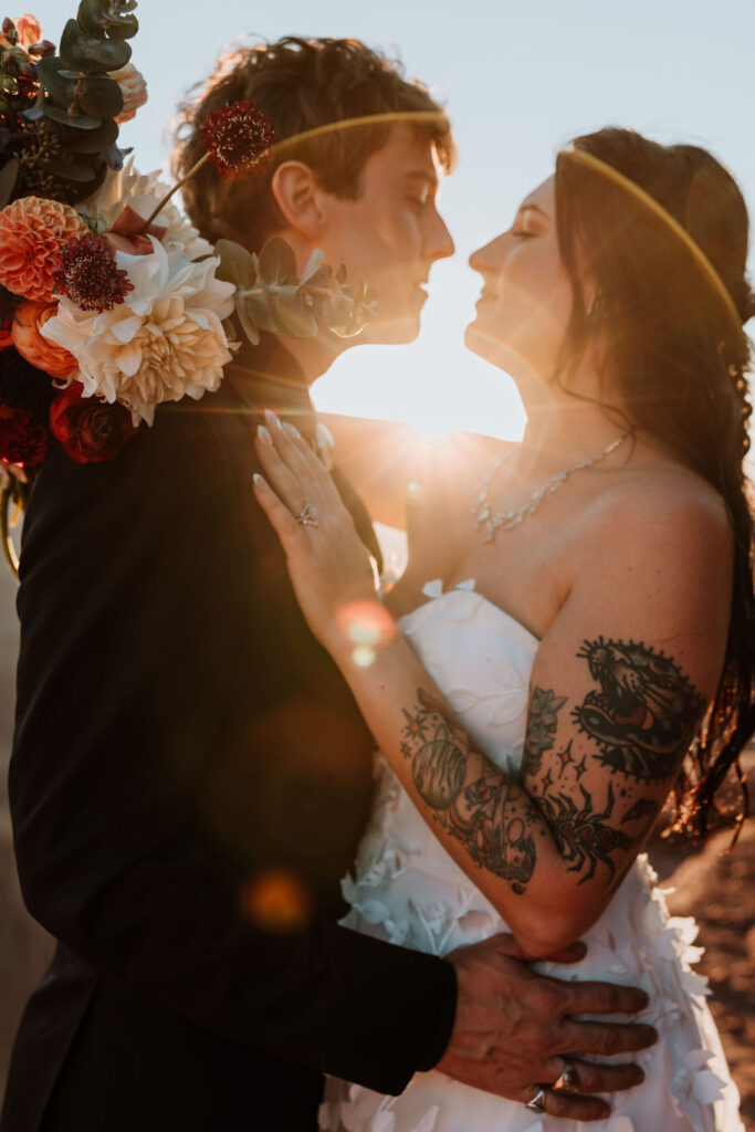 couple embraces at sunset elopement