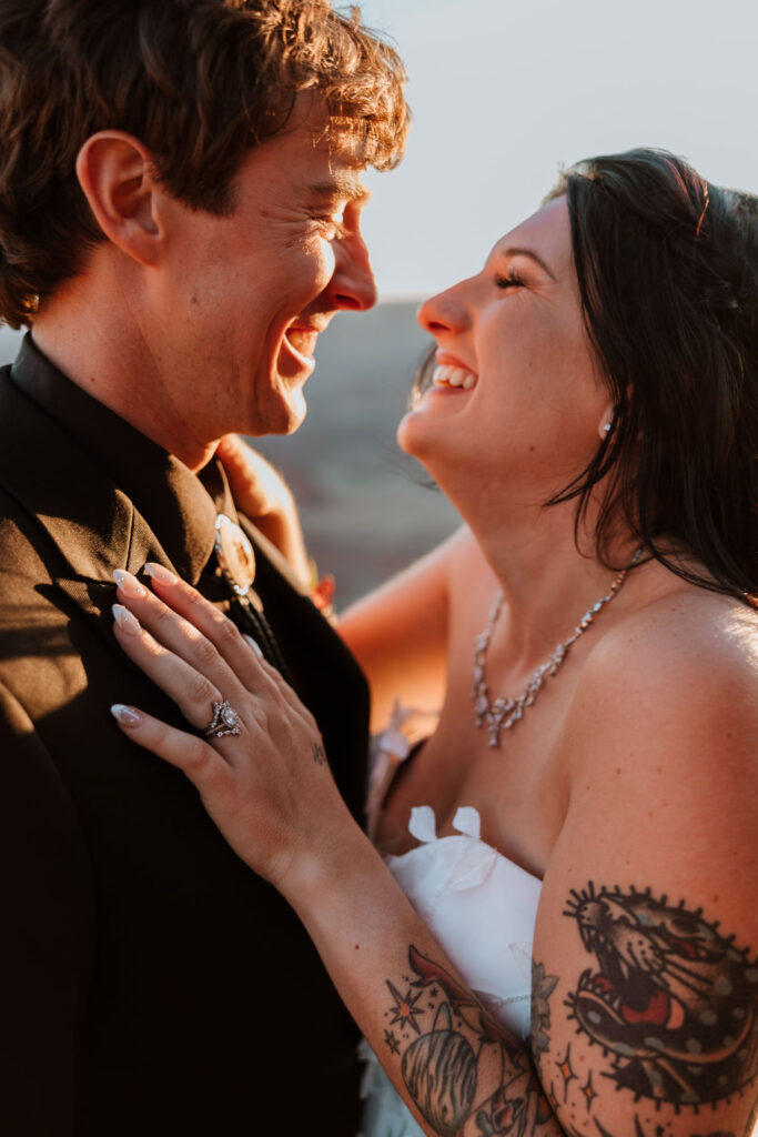 couple embraces at sunset elopement