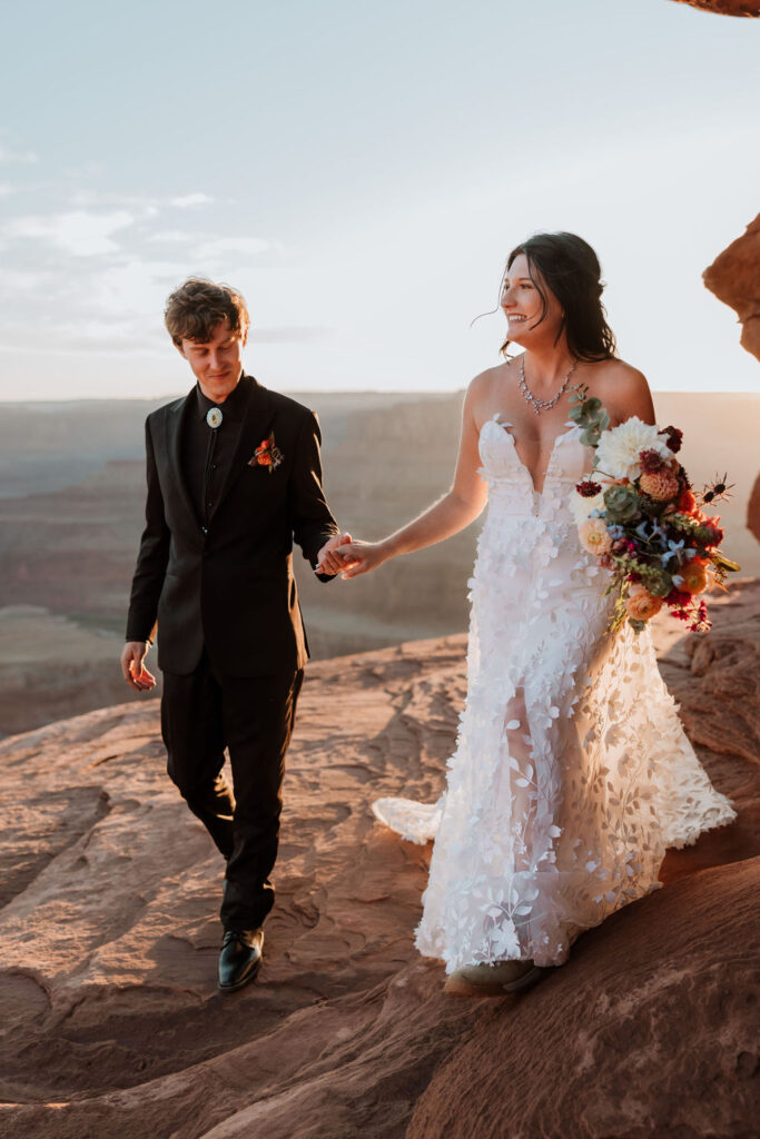 couple walks at Dead Horse Point State Park elopement