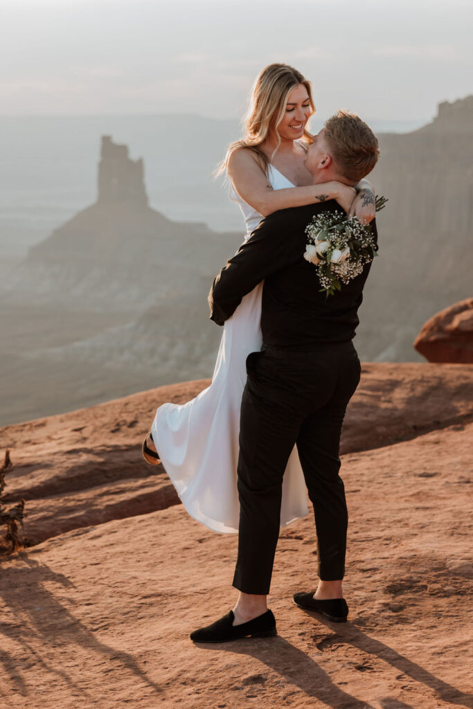 couple embraces at Moab elopement