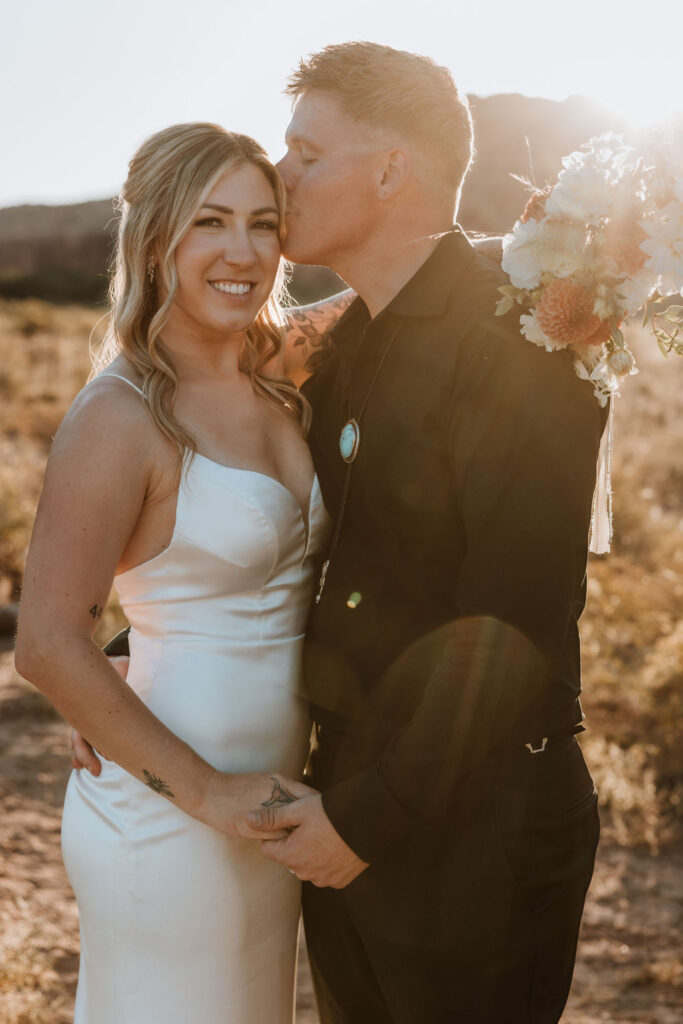 couple kisses at sunset elopement