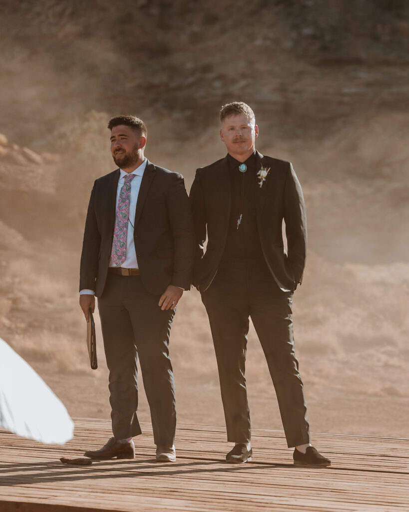 groom watches bride walk down the aisle