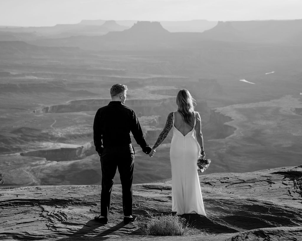 couple holds hands at Canyonlands elopement