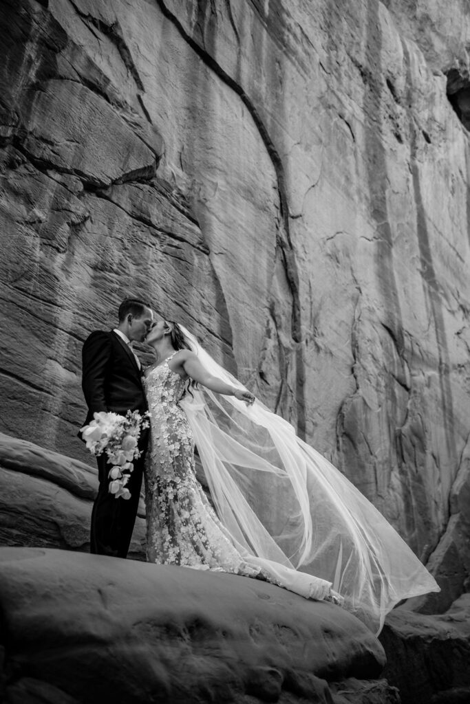 couple stands barefoot at Arches National Park elopement