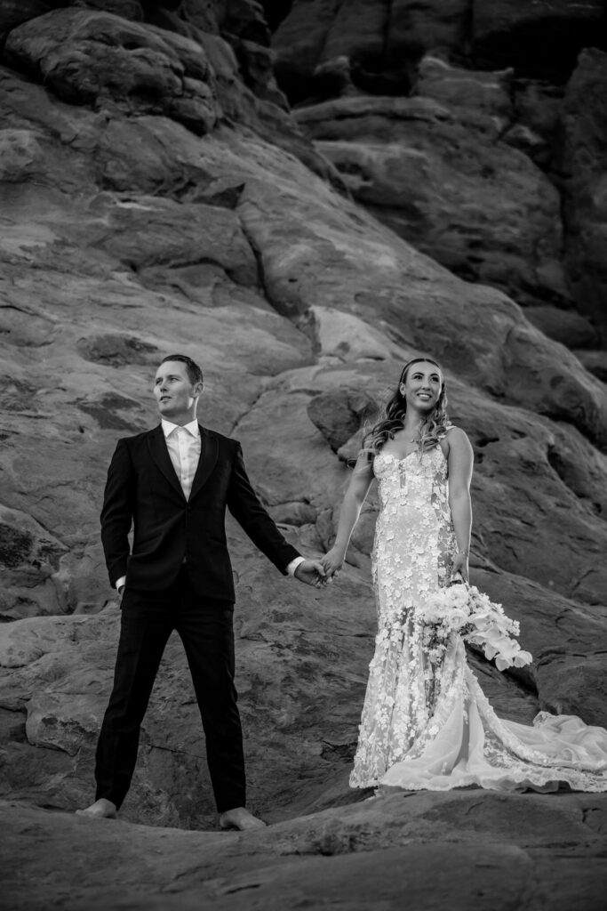 couple stands barefoot at Arches National Park elopement