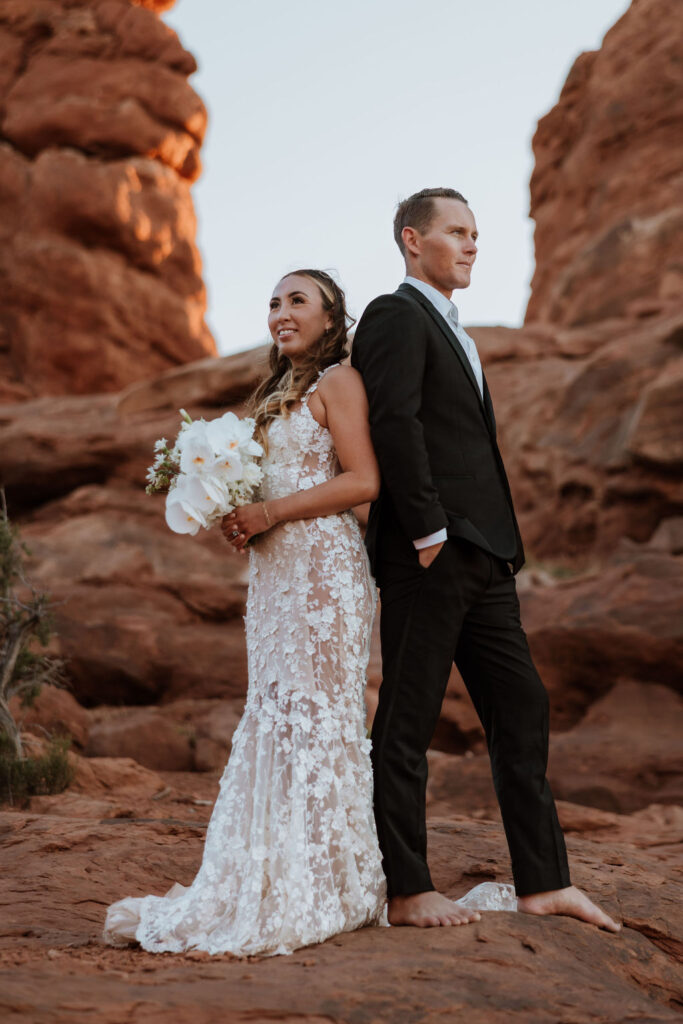 couple stands barefoot at Arches National Park elopement