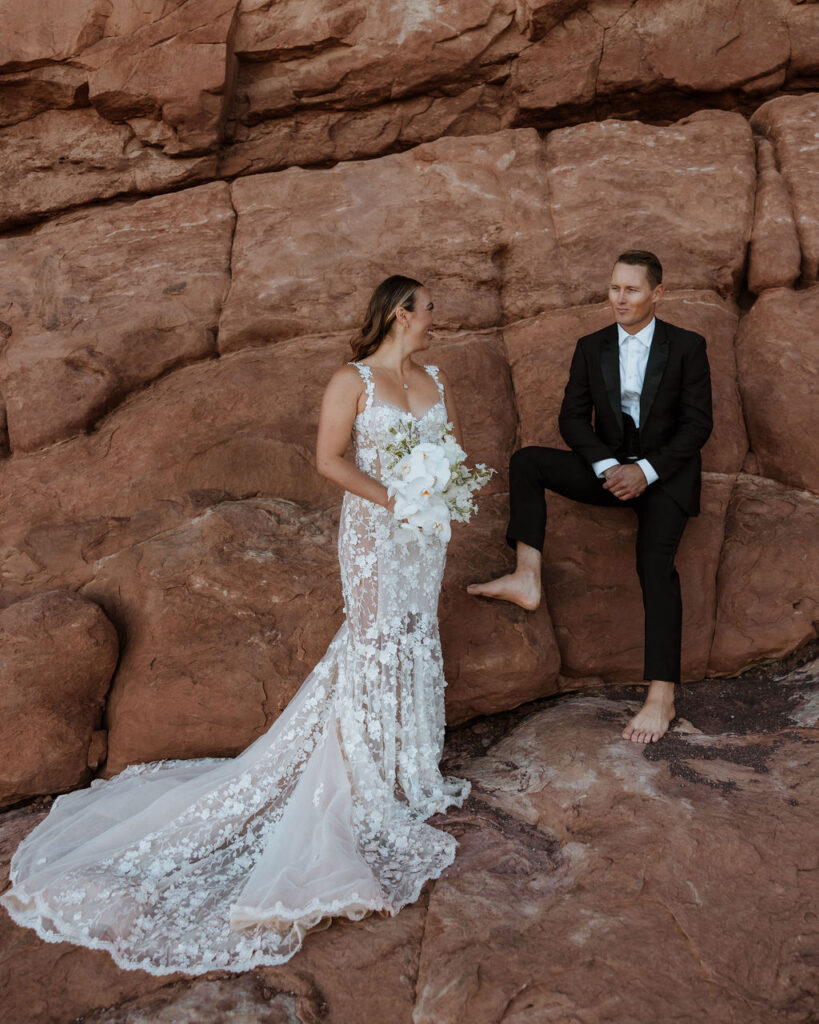 couple stands barefoot at Arches National Park elopement