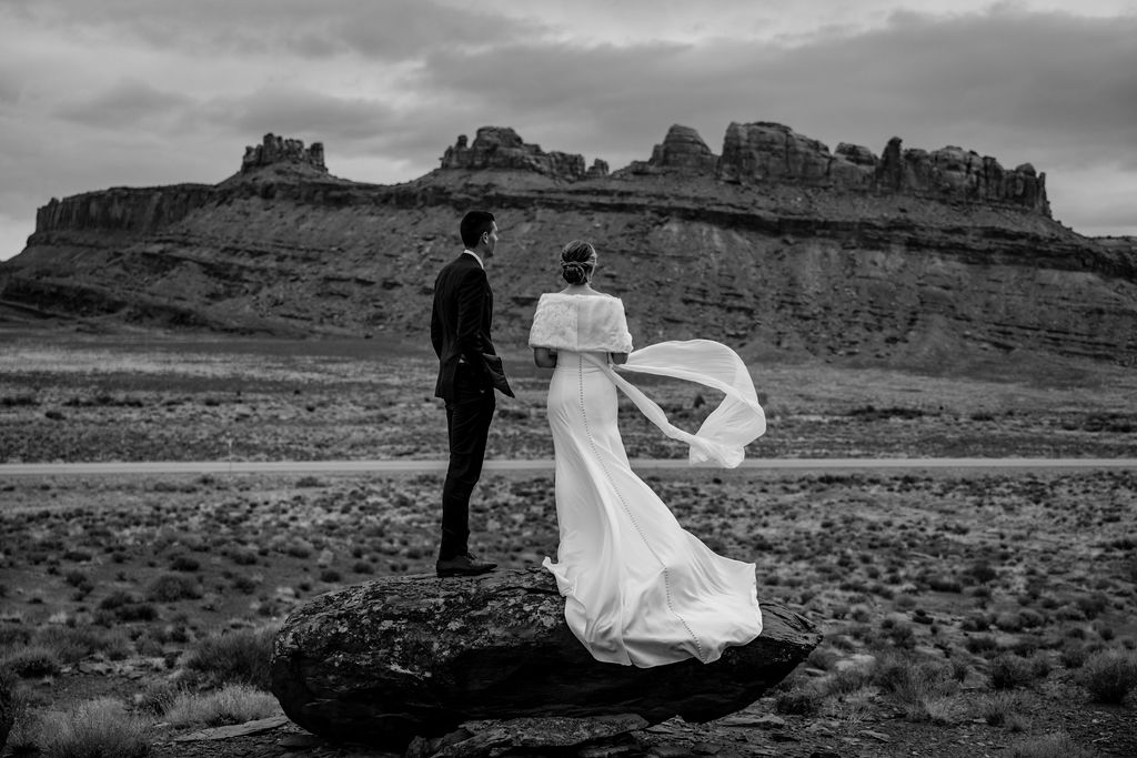 couple stands on rock at BLM land Moab Utah elopement