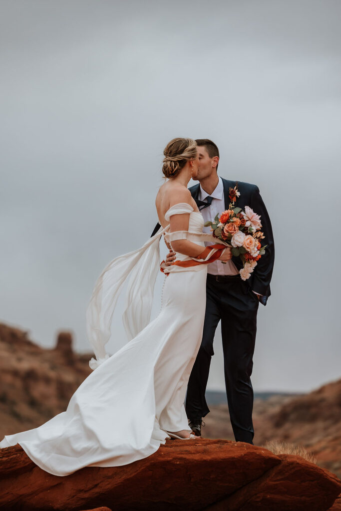 couple kisses at outdoor Moab elopement