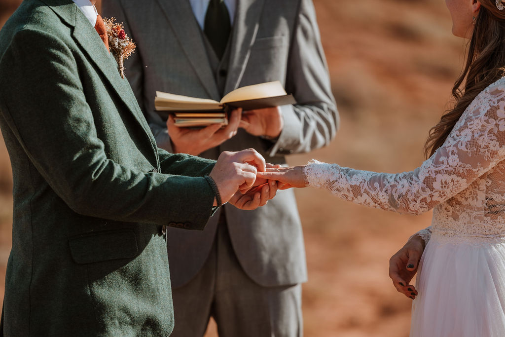 couple exchanges rings during Moab Utah elopement