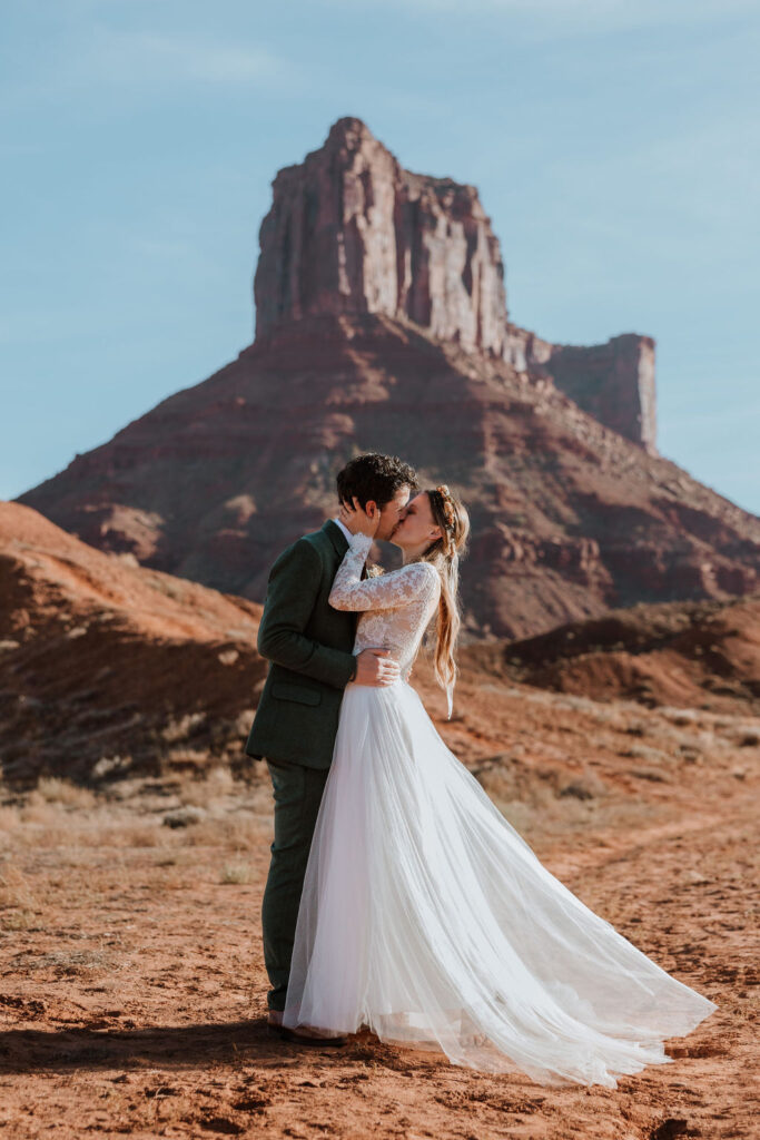 couple kisses at Moab desert outdoor elopement