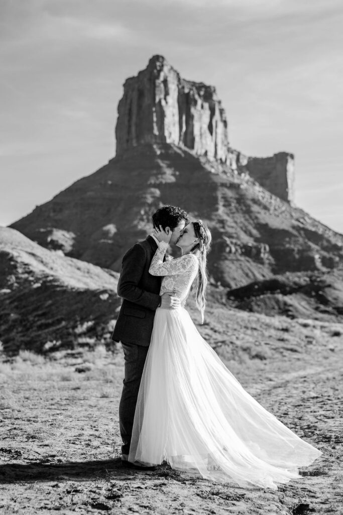 couple kisses at Moab desert outdoor elopement