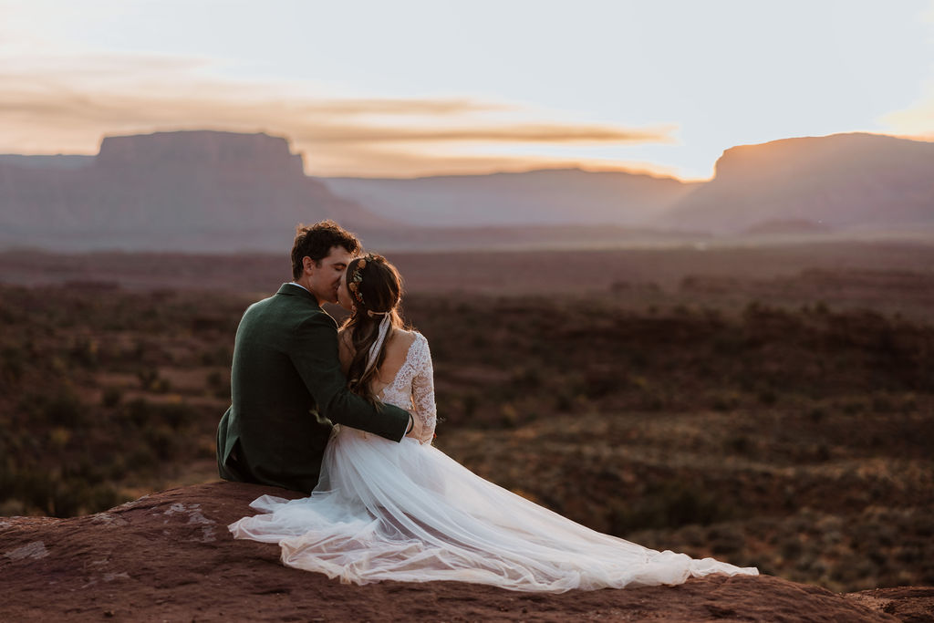 couple kisses at sunset Moab elopement