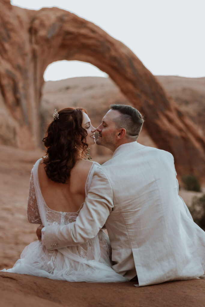 couple kisses at Corona Arch Moab elopement