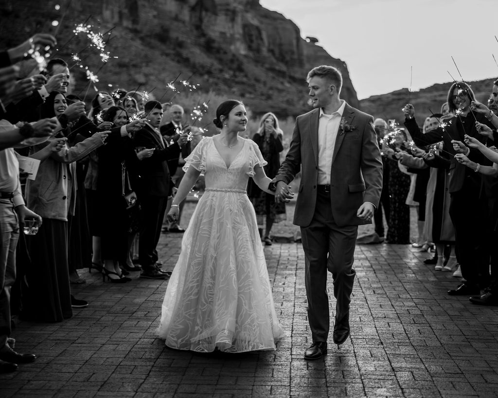 couple exits wedding under sparklers