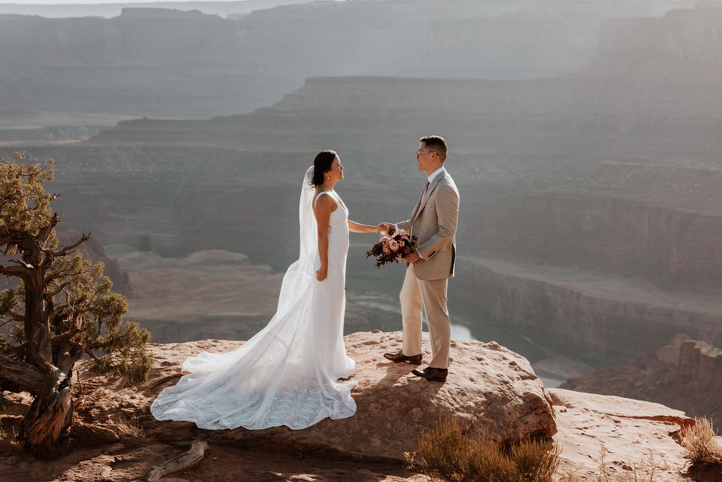 couple stands on overlook at Dead Horse Point Moab elopement