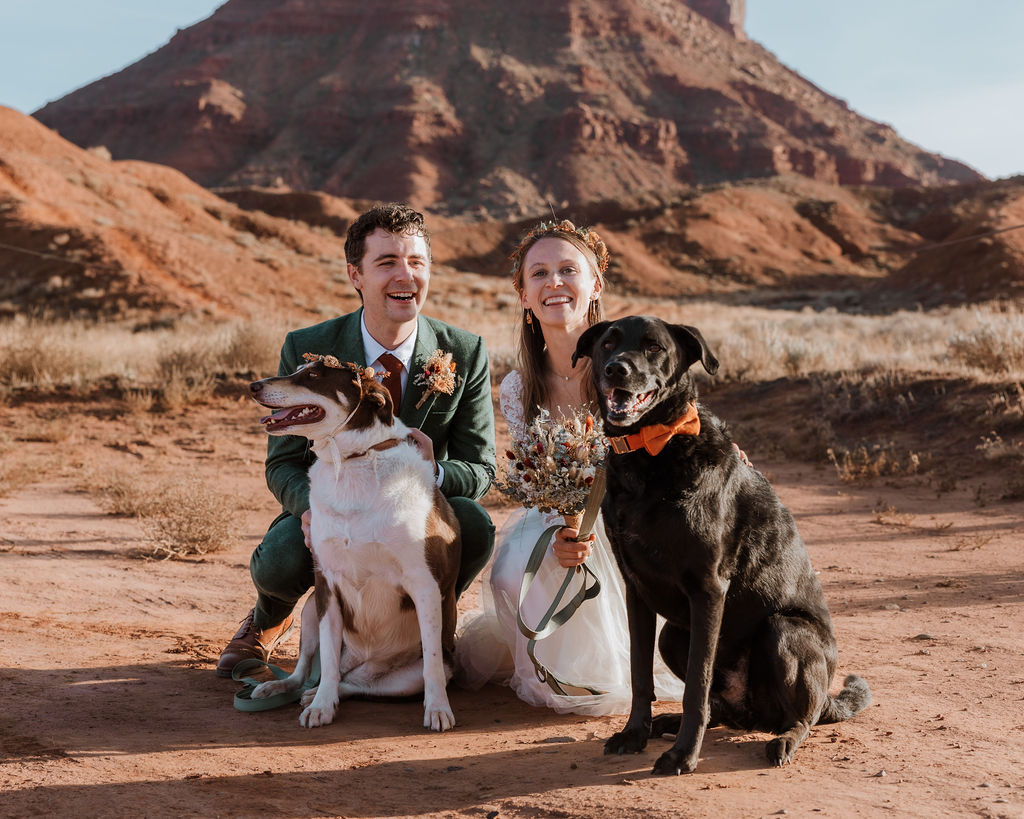 couple poses with dogs at Castle Valley Moab