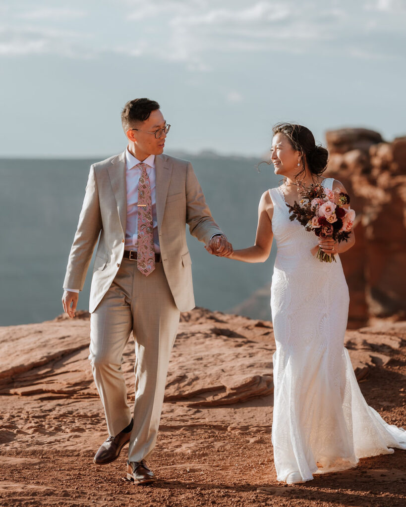 couple holds hands at Dead Horse Point elopement